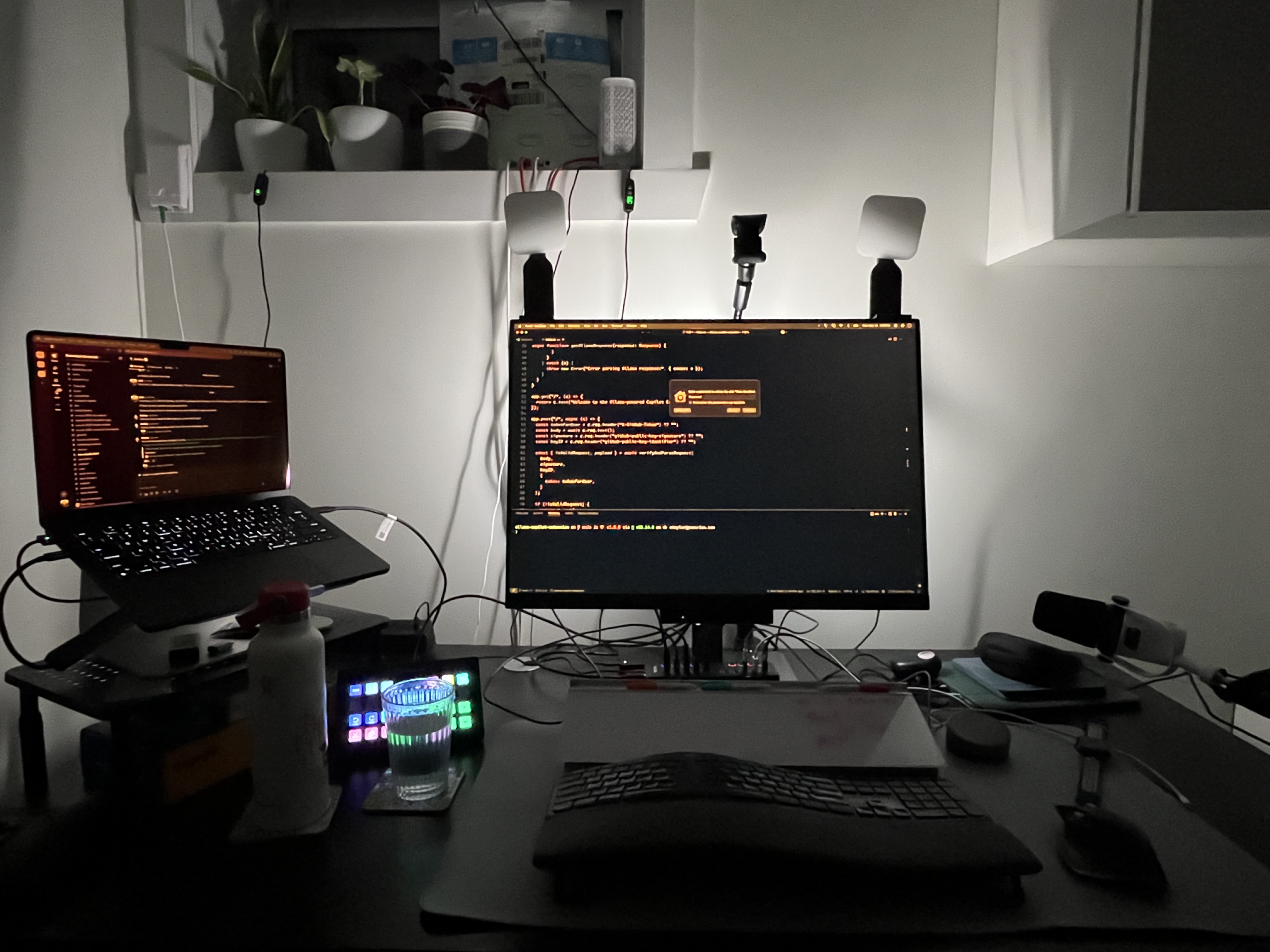 The BenQ monitor sitting on my desk with the Moonhalo light set to auto dimm where it's currently lit